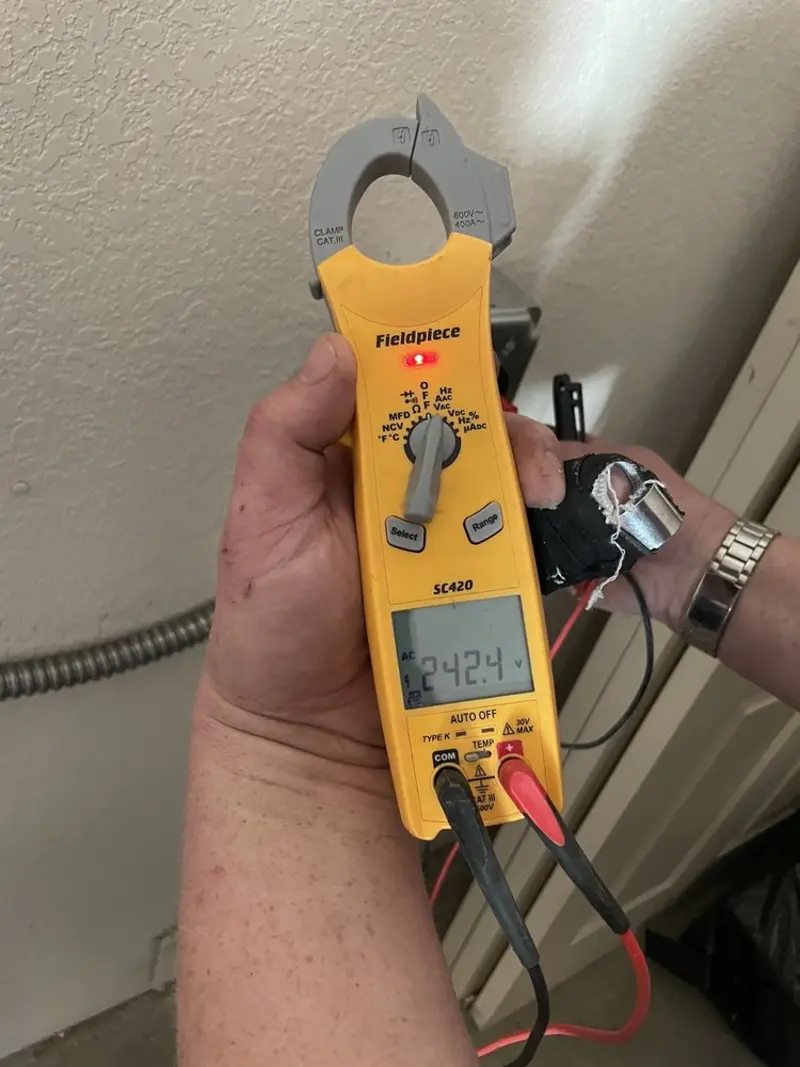 Voltage testing with clamp meter during Ceiling Fan Installation in Kochville